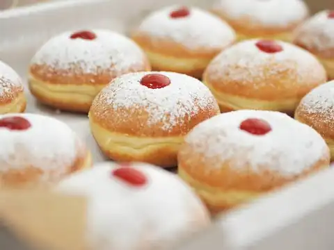 A plate of powdered jelly donuts